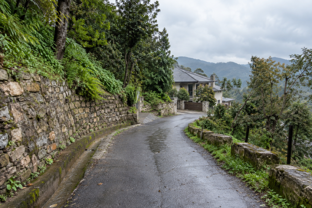 Mountain approach road, drainage and terrain near a Uttarakhand property